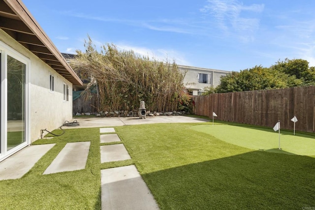 view of yard featuring a patio and a fenced backyard