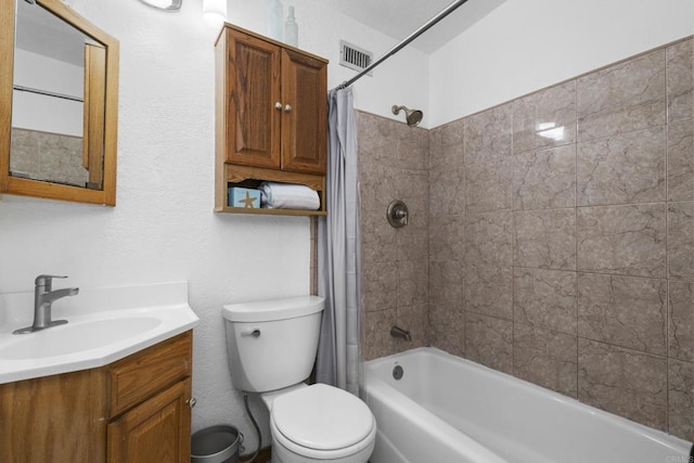 full bathroom featuring visible vents, vanity, toilet, and shower / tub combo