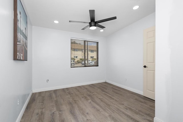 empty room with recessed lighting, ceiling fan, baseboards, and wood finished floors