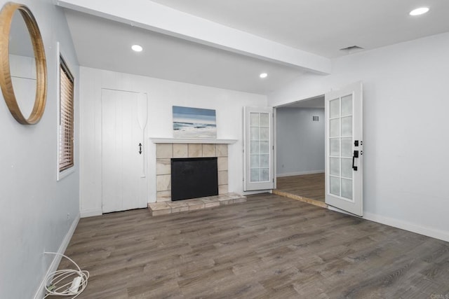 unfurnished living room featuring recessed lighting, a fireplace, and wood finished floors