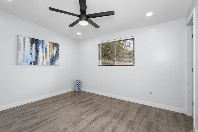 unfurnished room featuring wood finished floors, baseboards, and ceiling fan