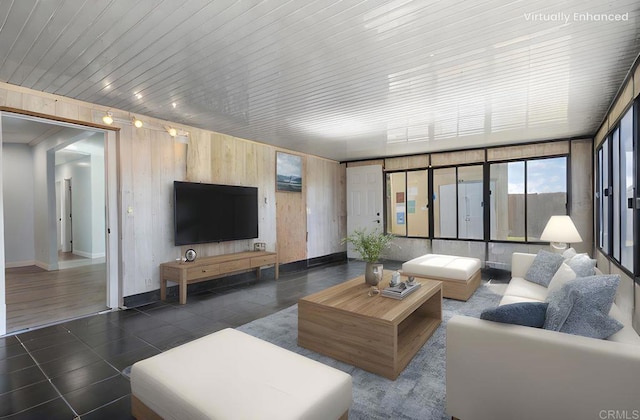 tiled living area with baseboards, wood walls, and wooden ceiling