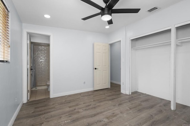 unfurnished bedroom featuring ensuite bath, recessed lighting, wood finished floors, and visible vents