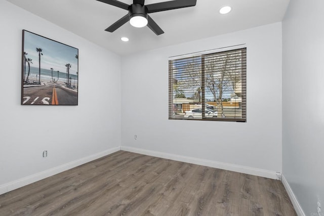 empty room with a ceiling fan, recessed lighting, wood finished floors, and baseboards