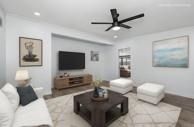 living area featuring baseboards, ornamental molding, recessed lighting, wood finished floors, and a ceiling fan