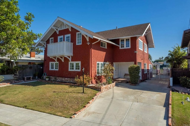 view of front of property featuring a front yard, a balcony, a gate, fence, and driveway