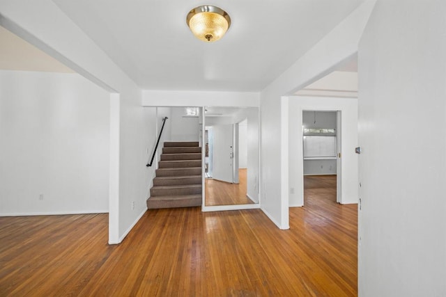 staircase featuring baseboards and hardwood / wood-style floors