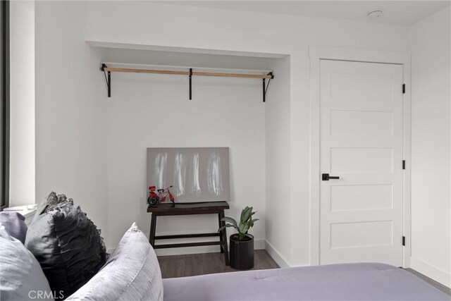 bedroom featuring baseboards and wood finished floors