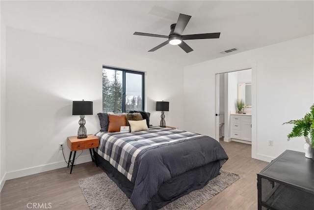 bedroom featuring visible vents, baseboards, and wood finished floors