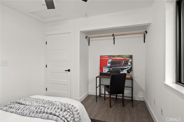 bedroom with a ceiling fan, wood finished floors, and baseboards