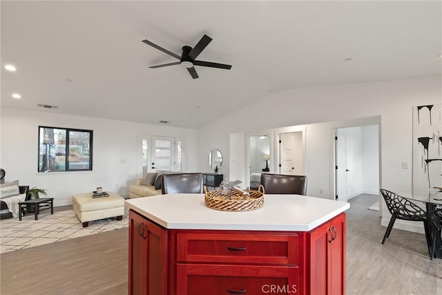 kitchen featuring light wood-type flooring, dark brown cabinets, open floor plan, and ceiling fan