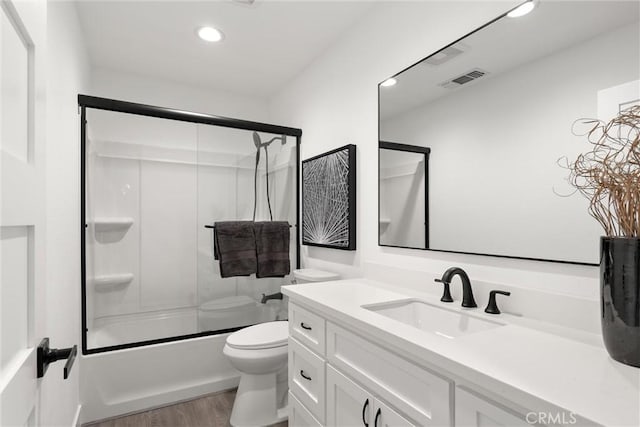 full bathroom featuring visible vents, toilet, wood finished floors, recessed lighting, and vanity