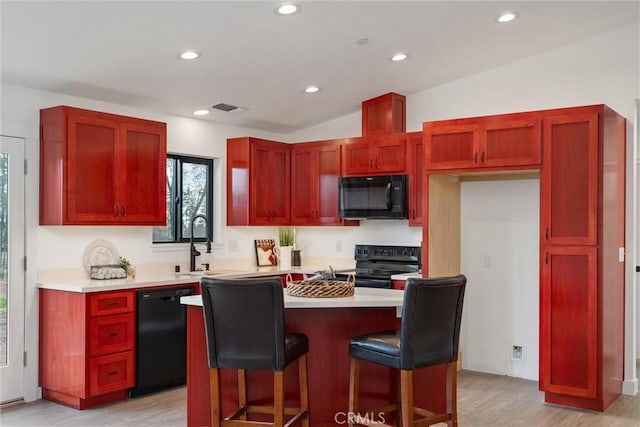 kitchen featuring visible vents, recessed lighting, black appliances, light countertops, and reddish brown cabinets