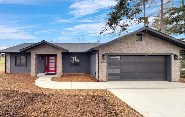 ranch-style house with concrete driveway, a garage, stone siding, and a shingled roof