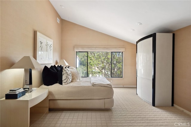 bedroom featuring baseboards and lofted ceiling