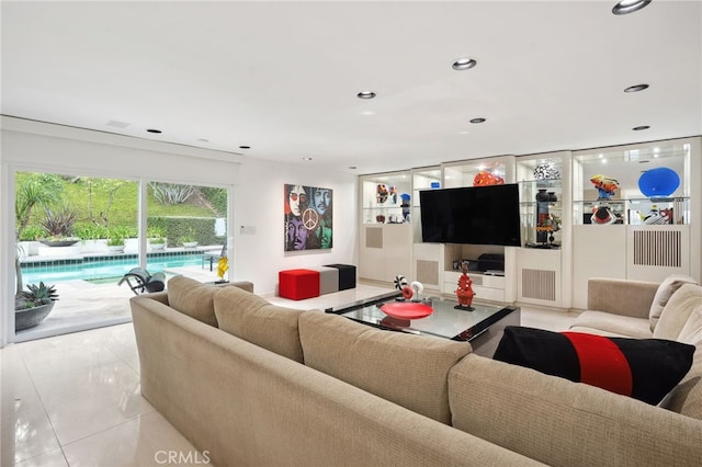 living area featuring light tile patterned flooring and recessed lighting