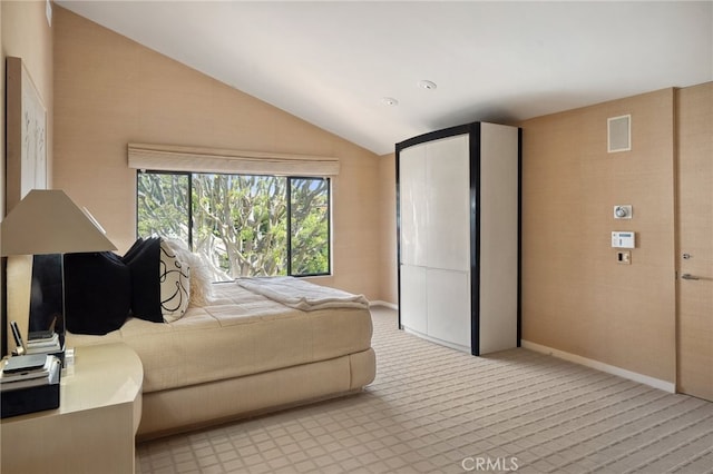 bedroom with baseboards and lofted ceiling