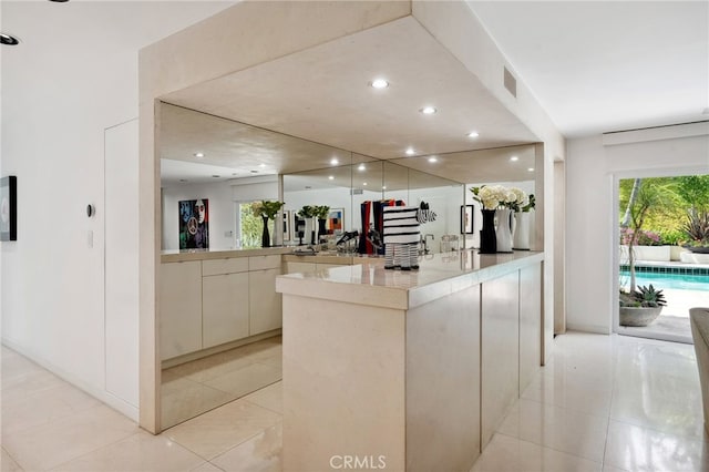 kitchen featuring plenty of natural light, modern cabinets, visible vents, and light tile patterned floors