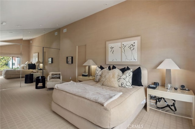 carpeted bedroom featuring high vaulted ceiling