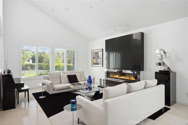 living area featuring light tile patterned floors, a fireplace, high vaulted ceiling, and baseboards