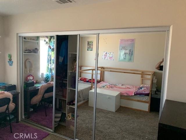 carpeted bedroom featuring a closet