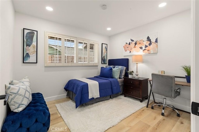 bedroom with recessed lighting, baseboards, and wood finished floors