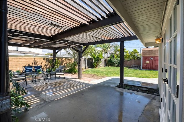 view of patio with an outdoor structure, a fenced backyard, a pergola, and a shed