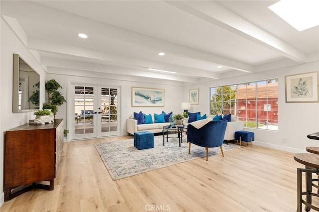 living room featuring wood finished floors, baseboards, beam ceiling, recessed lighting, and french doors