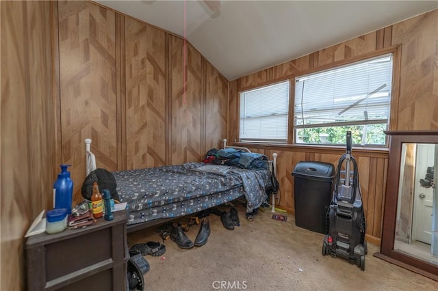 carpeted bedroom featuring wood walls and lofted ceiling