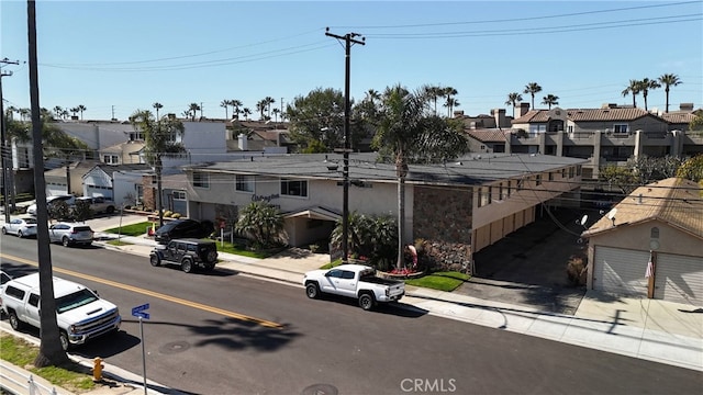 view of road featuring curbs, sidewalks, and a residential view