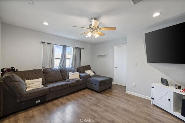 living room with a ceiling fan, visible vents, baseboards, recessed lighting, and light wood-type flooring