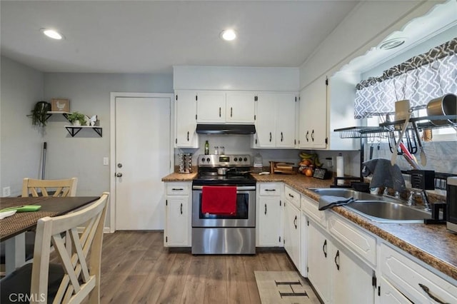 1301 Orange Ave, Chowchilla, CA 93610 - kitchen featuring under cabinet range hood, stainless steel electric range, wood finished floors, white cabinetry, and a sink