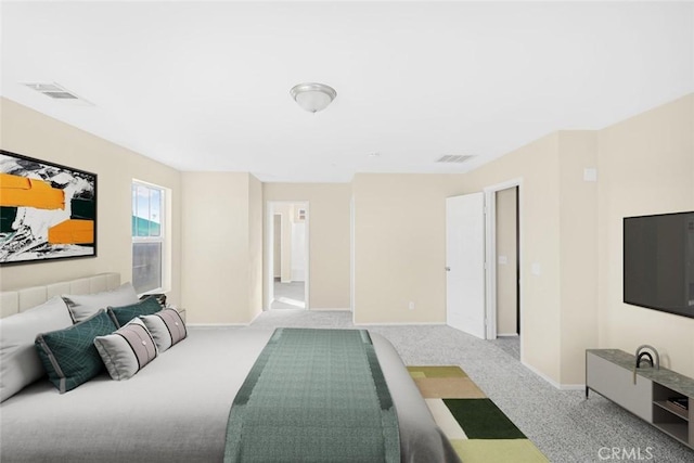 bedroom featuring visible vents, baseboards, and carpet