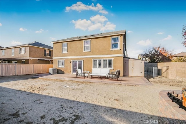 rear view of property with a patio, cooling unit, a fenced backyard, stucco siding, and an outdoor hangout area