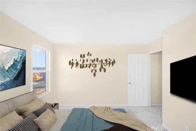 carpeted bedroom featuring baseboards