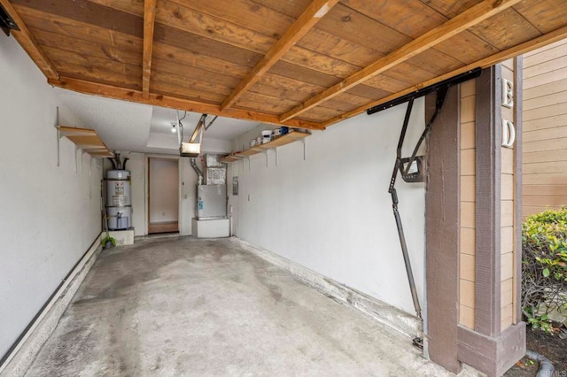 garage with water heater, wood ceiling, and a garage door opener