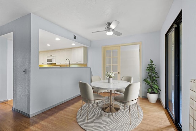 dining room featuring light wood-style flooring, recessed lighting, visible vents, and ceiling fan