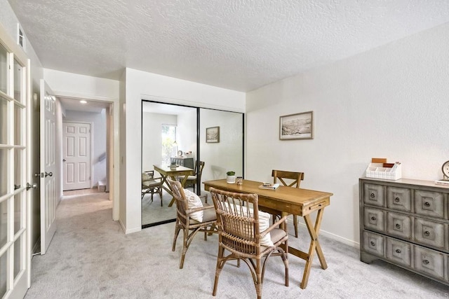 4015 Canario St Unit D, Carlsbad, CA 92008 - dining space featuring light carpet, a textured ceiling, a desk, and french doors