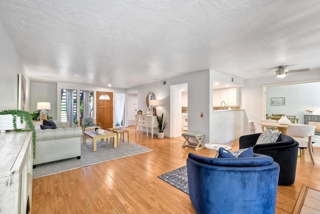 4015 Canario St Unit D, Carlsbad, CA 92008 - living room featuring light wood-style floors, a textured ceiling, and ceiling fan