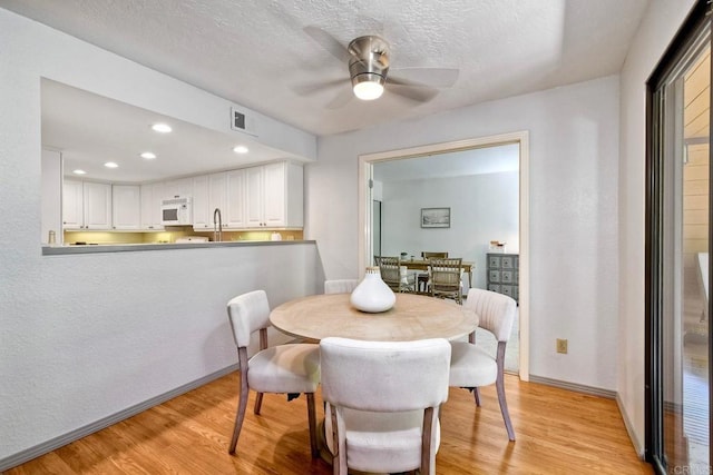 4015 Canario St Unit D, Carlsbad, CA 92008 - dining area with a ceiling fan, light wood-style floors, a textured ceiling, and recessed lighting