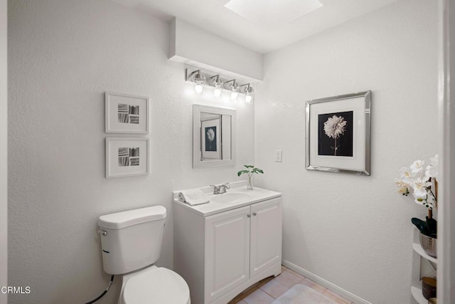 bathroom featuring tile patterned floors, toilet, and vanity