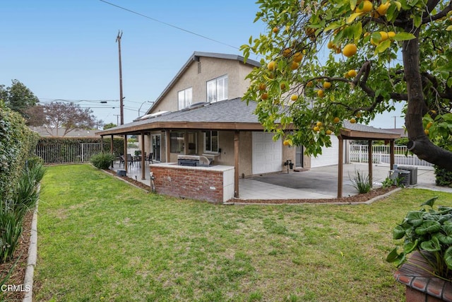 rear view of house featuring area for grilling, a yard, a fenced backyard, stucco siding, and a patio area