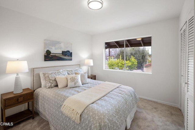 bedroom with carpet flooring and baseboards