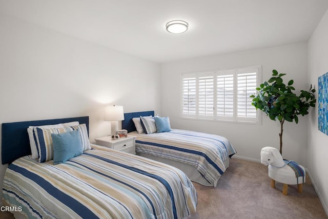 bedroom featuring baseboards and carpet