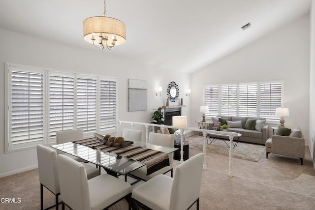 dining space with visible vents, baseboards, carpet, vaulted ceiling, and a notable chandelier