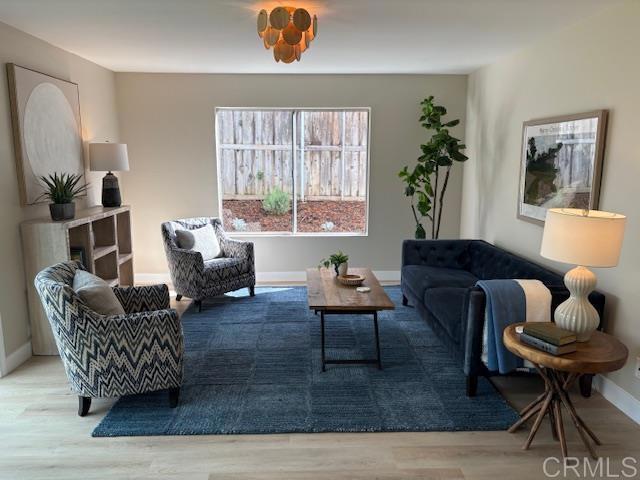 living area featuring baseboards and wood finished floors