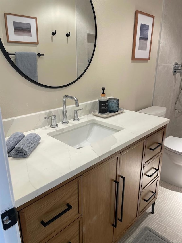 bathroom featuring vanity and toilet