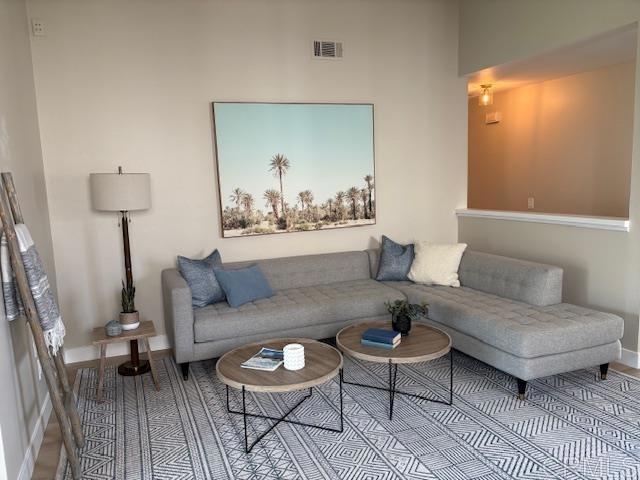 living area with visible vents and baseboards