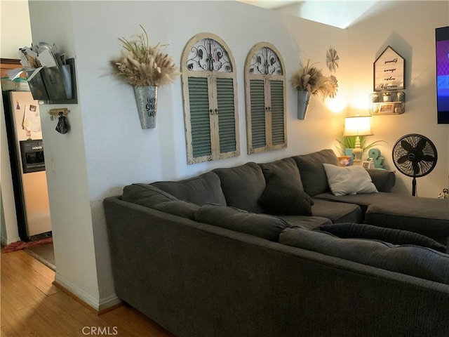 living room with baseboards and wood finished floors