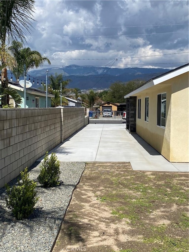 view of patio / terrace with a mountain view and fence